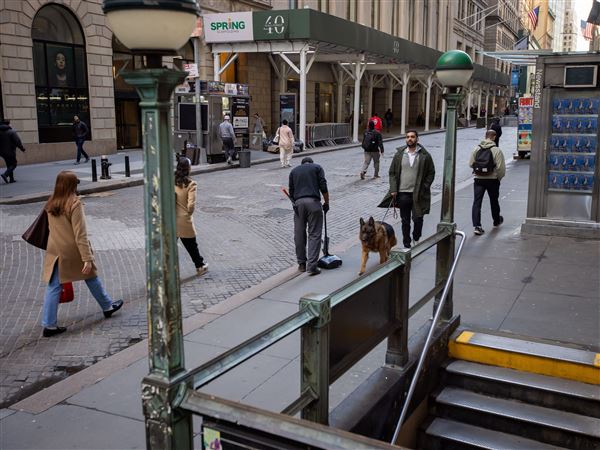 Pedestrians walk along Wall Street across from the New York Stock Exchange (NYSE) on Thursday, April 17, 2025, in the Financial District neighborhood of New York City’s Manhattan borough.