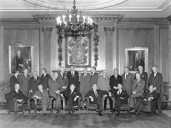 An undated photo of the Allegheny Conference on Community Development Executive Committee at Pittsburgh’s Duquesne Club: Seated, from left, Edward J. Hanley, vice president of the conference and president, Allegheny Ludlum Steel Corporation; Edward J. Magee, executive director of the conference; Leon Falk Jr., industrialist; John T. Ryan Jr., chairman of the conference and president, Mine Safety Appliances Co.; Carl B. Jansen, president of the conference and chairman of board, Dravo Corp.; Gwilym A. Price, vice president of the conference and chairman of board, Westinghouse Electric Corp.; Leslie B. Worthington, president, U.S. Steel Corp.; John A. Mayer, vice president of the conference and president, Mellon National Bank and Trust Co. Standing, from left: John J. Grove, assistant director of the conference; Frank L. Magee, chairman, executive committee, Aluminum Company of America (Alcoa Corp.); Dr. Edward R. Weidlein, former chairman, of the conference and retired president, Mellon Institute; George A. Shoemaker, president, Consolidation Coal Co.; J. Stanley Purnell, assistant to the president, T. Mellon and Sons; William H. Rea, president, Oliver Tyrone Corp.; David G. Hill, president, Pittsburgh Plate Glass Co.; Henry L. Hillman, president, Pittsburgh Coke and Chemical Co.; Arthur B. Van Buskirk, former chairman of the conference and vice president and governor, T. Mellon and Sons; A.W. Schmidt, former chairman of the conference and president, The A.W. Mellon Educational and Charitable Trust; James M. Bovard, secretary of the conference and president, Carnegie Institute; Theodore L. Hazlett Jr., solicitor; and Patrick J. Cusick Jr., assistant director of the conference. Portraits on the wall, from left: Andrew W. Mellon and Richard Beatty Mellon. (Detre Library & Archives, Heinz History Center)