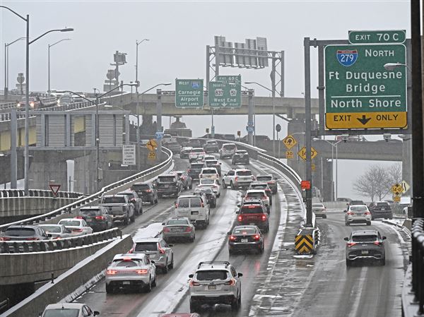 Traffic backs up on a snowy afternoon on the Parkway West in Downtown. 
